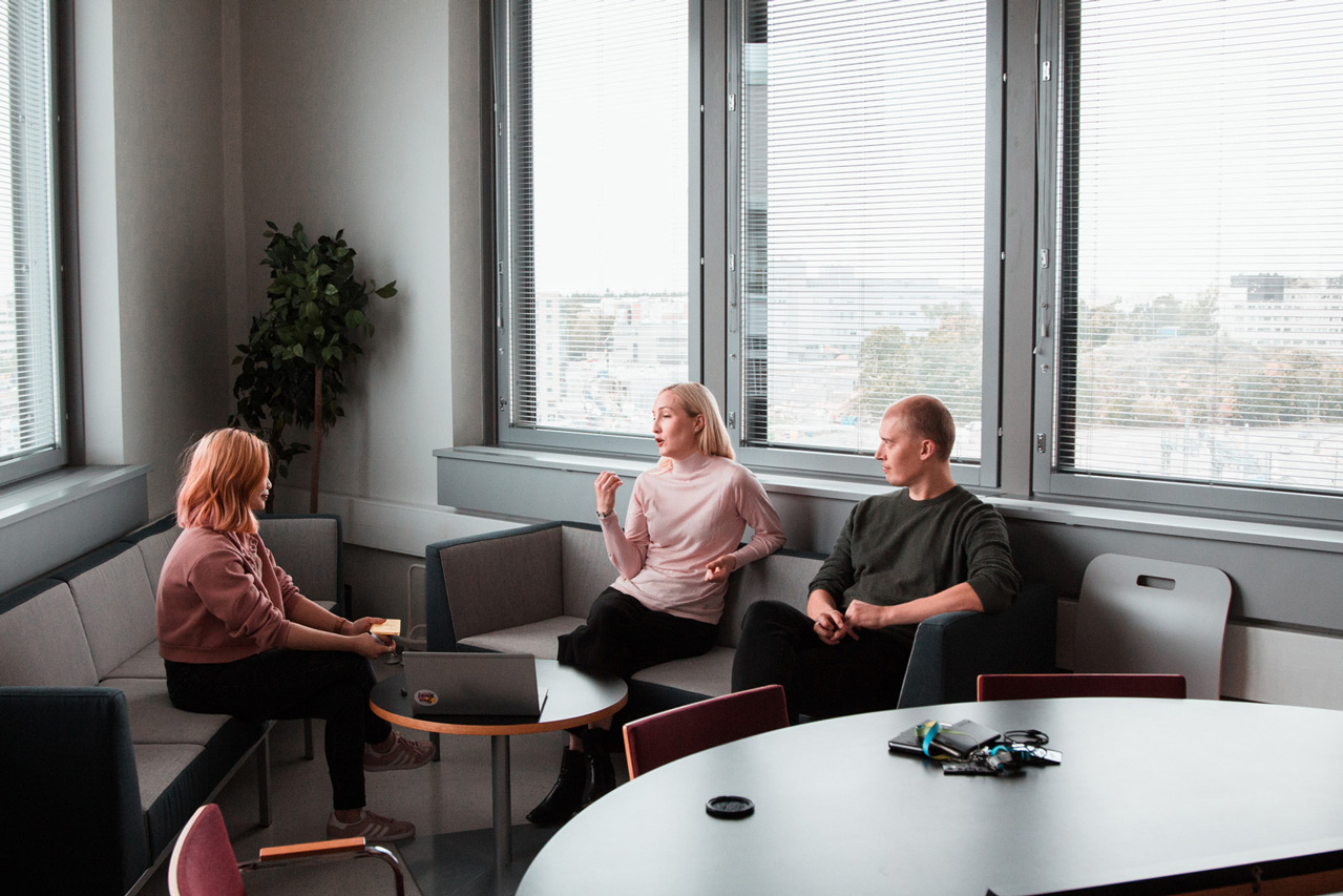 Three people talking in an office